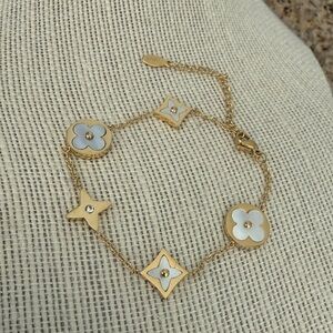 Gold tone stainless steel Bracelet with White Floral Charms